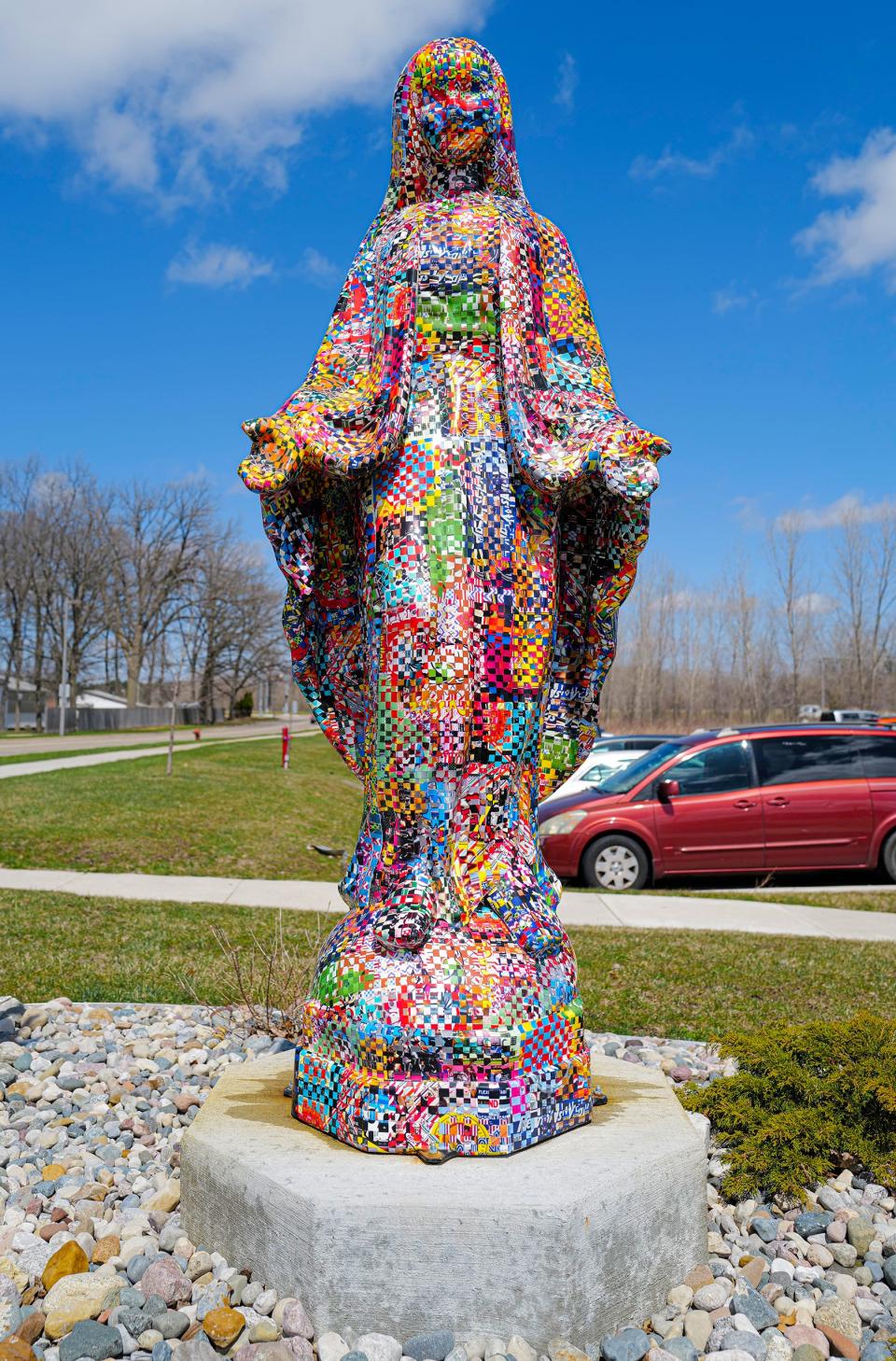 This seven-foot technicolor statue of the Virgin Mary by Jonpaul Smith is made of fiberglass with a brightly colored pattern. It's on Coolidge Road in East Lansing, photographed Thursday, April 21, 2022.