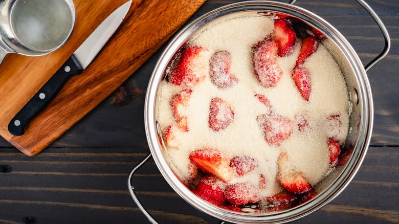 Strawberries macerating in silver bowl