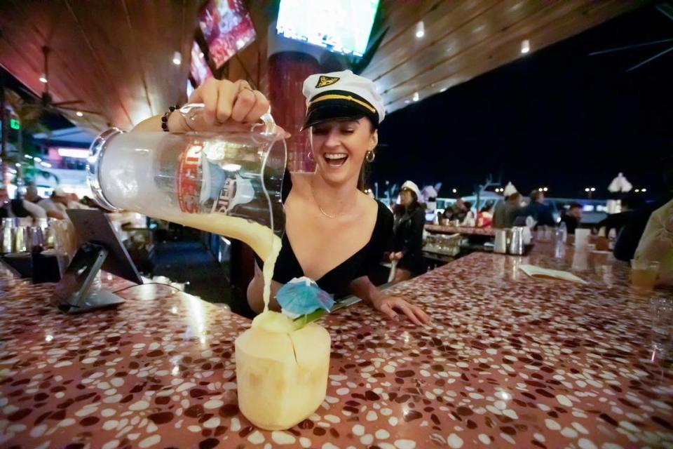 Bartender Shelby Flannigan makes a “Coquito” cocktail with vanilla, white rum, cinnamon, coconut cream, eggnog, coconut milk and condensed milk at The Rum Bar at Pier 5 at Bayside Marketplace in Miami. Alexia Fodere/For The Miami Herald