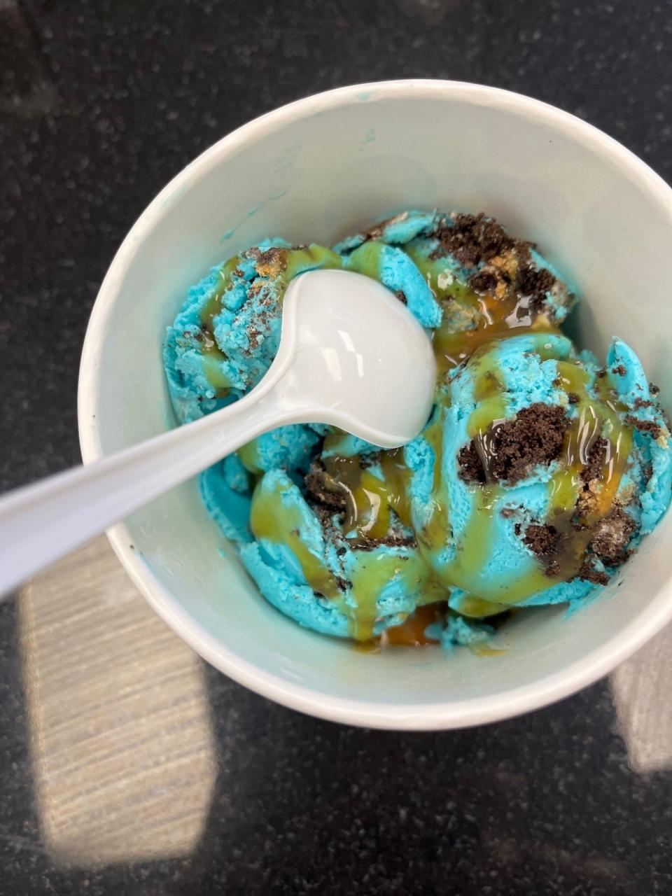 A cup of Fox Island Creamery's Cookie Monster ice cream shown with a caramel sauce.   That flavor is the favorite among kids. The creamery is located in the Cosmos Supermarket in Hewitt section of West Milford.