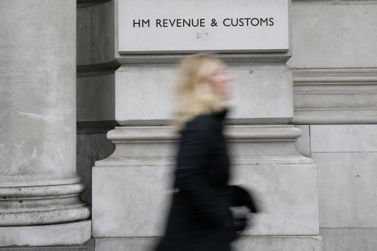 A pedestrian walks past the headquarters of Her Majesty's Revenue and Customs (HMRC) in central London February 13, 2015. British lawmakers plan to call up the bosses of HSBC and the tax authority, HMRC, to quiz them over allegations some clients of HSBC's Swiss private bank evaded tax.     REUTERS/Stefan Wermuth (BRITAIN - Tags: BUSINESS POLITICS CRIME LAW)