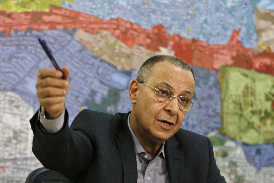 In this Thursday, June 20, 2019 photo, George Aoun, head of the municipality of the village of Hadat, speaks during an interview with The Associated Press at his office in the Christian village of Hadat, where only Christians can rent or buy property, near Beirut, Lebanon. The town's Muslim ban, imposed years ago, has recently sparked a national outcry. The case reflects Lebanon's rapidly changing demographic make-up against the backdrop of deep-rooted sectarian divisions that once erupted into a 15-year civil war. (AP Photo/Bilal Hussein)