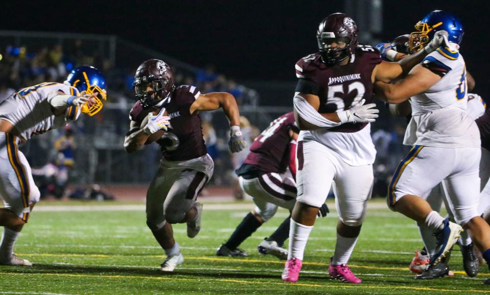 Appoquinimink's Ja'den Glover (5) pushes through an opening in front of blocker Miko Gibson (52) and scores to start the Jaguar comeback in the fourth quarter of Appoquinimink's 31-30 comeback win against Susex Central at home, Friday, Oct. 6, 2023. The play cut the Golden Knights lead to 30-19.