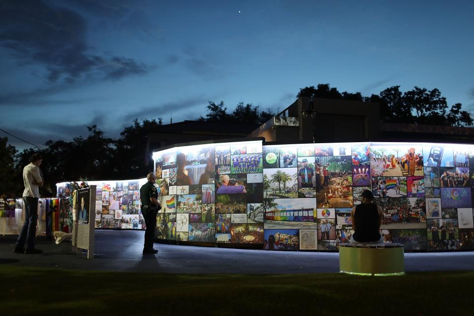 People visit the memorial to the 49 shooting victims