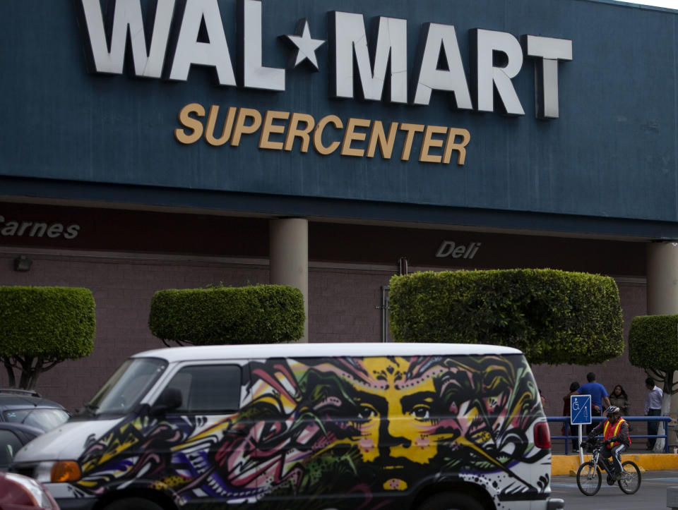 A van covered by a mural sits parked outside a Walt-Mart Super Center in Mexico City, Saturday, April 21, 2012. Wal-Mart Stores Inc. hushed up a vast bribery campaign that top executives of its Mexican subsidiary carried out to build stores across Mexico, according to a published report by the New York Times. Wal-Mart is Mexico's largest private employer. (AP Photo/Dieu Nalio Chery)