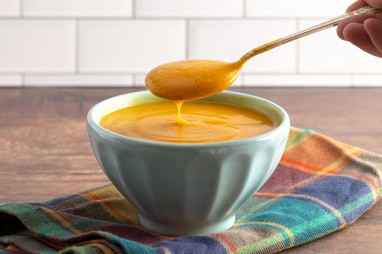 Healthy Sweet Potato and Sage Soup on a Rustic Wooden Table