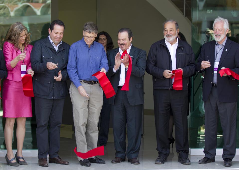 From left, Chair of the International Center for Improvement of Corn and Wheat (CIMMYT) Sara Boettiger, Mexico state Gov. Eruviel Avila, Microsoft Chairman Bill Gates, Mexican Secretary of Agriculture Enrique Martinez, Mexican telecommunications tycoon Carlos Slim and CIMMYT Director General Thomas Lumpkin cut the ribbon at inauguration of the new research center for the CIMMYT in Texcoco, Mexico, Wednesday, Feb. 13, 2013. Gates and Slim teamed up to to fund new seed breeding research which the CIMMYT says aims to sustainably increase the productivity of maize and wheat systems to ensure global food security and reduce poverty. (AP Photo/Eduardo Verdugo)