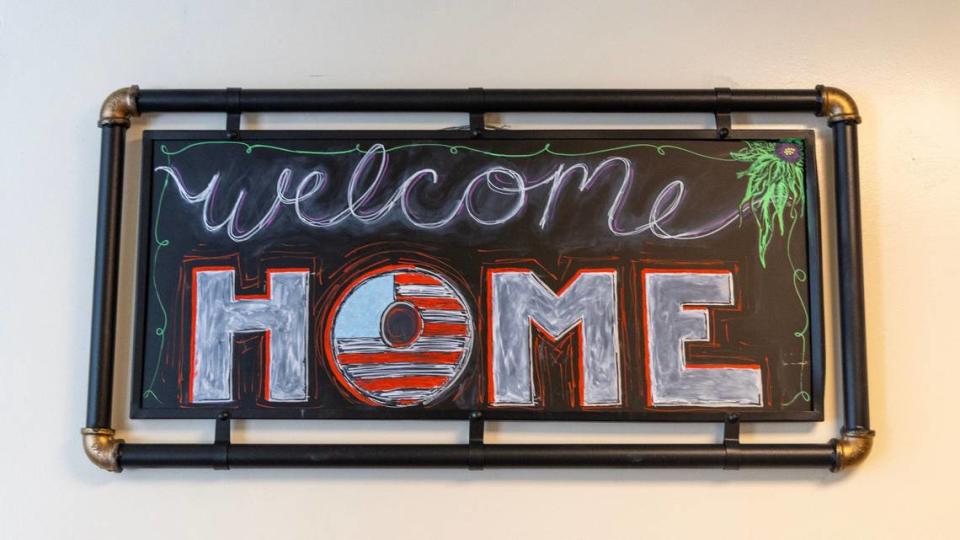 A patriotic sign greets residents in the hallway of Valor Pointe, an apartment complex for veterans experiencing homelessness.