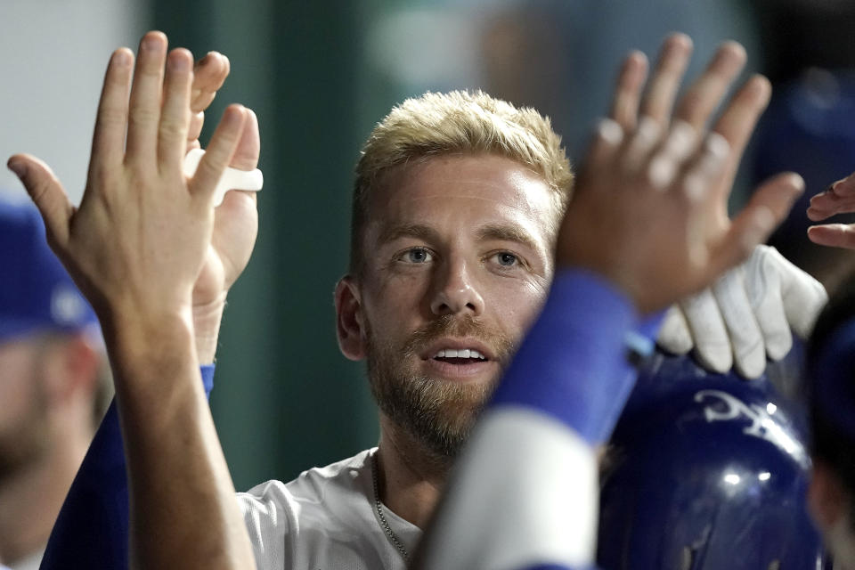 Kansas City Royals' Hunter Dozier celebrates in the dugout after hitting a solo home run during the fifth inning of a baseball game against the Minnesota Twins Tuesday, Sept. 20, 2022, in Kansas City, Mo. (AP Photo/Charlie Riedel)