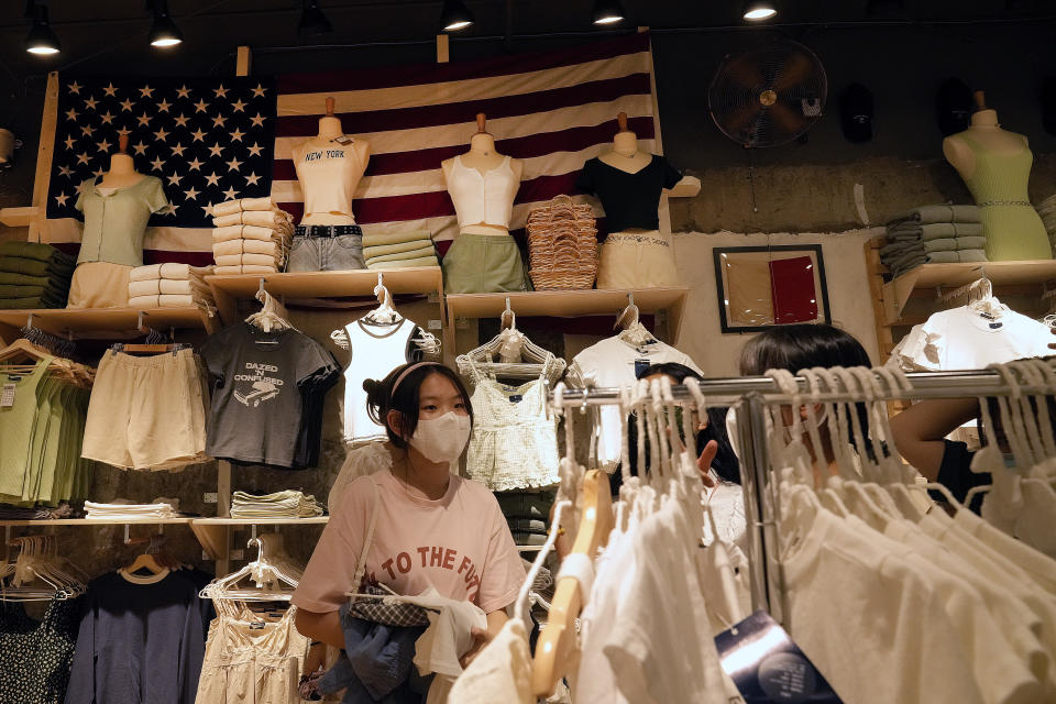 Women wearing face masks shop at an American fashion boutique in Beijing on Sunday, July 11, 2021. China on Tuesday, July 13, denounced an appeal by Treasury Secretary Janet Yellen for a U.S.-European "unified front" against Chinese "unfair economic practices" and human rights abuses. (AP Photo/Andy Wong)