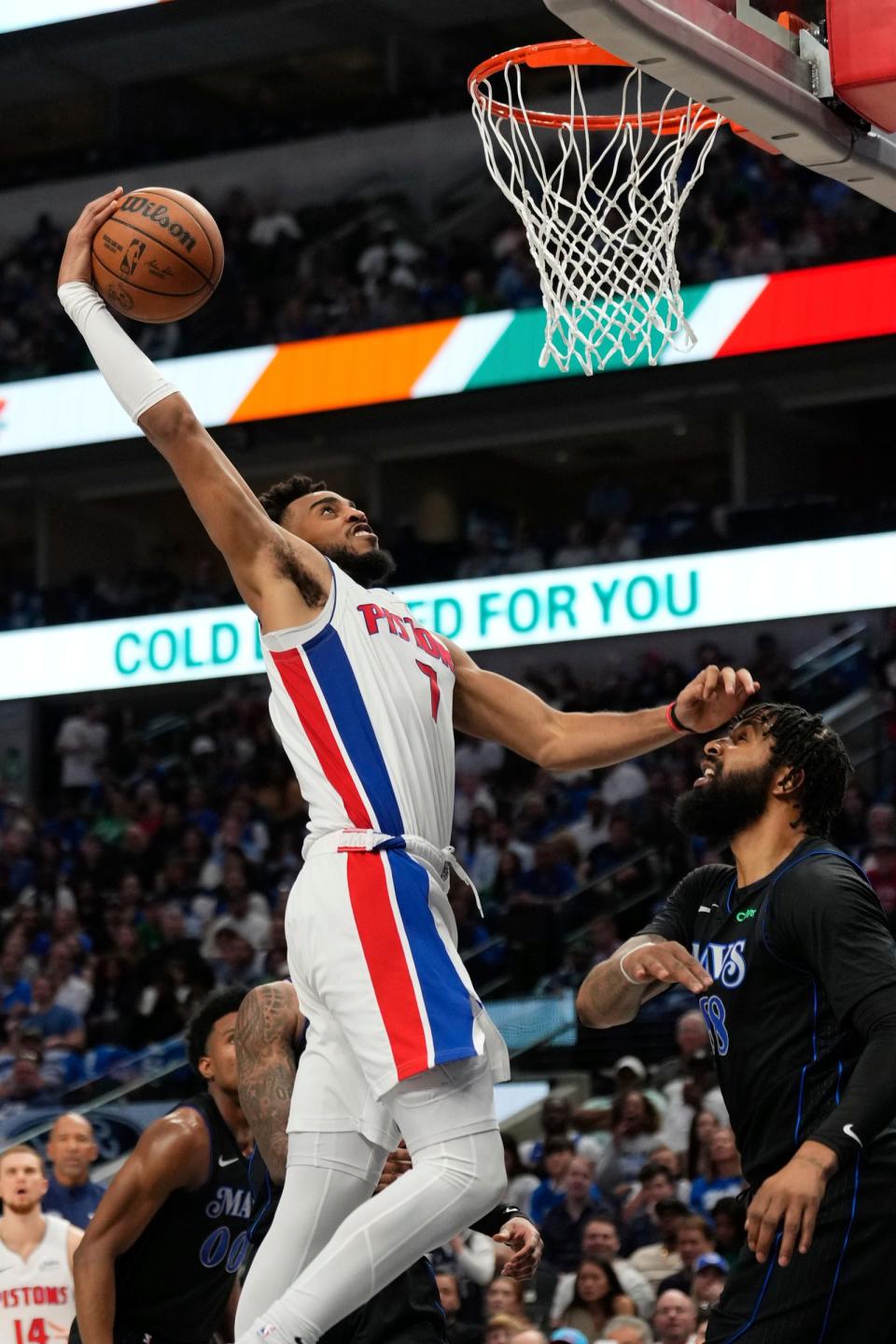 Pistons forward Troy Brown Jr. dunks the ball against Mavericks forward Markieff Morris during the second half of the Pistons' 107-89 win on Friday, April 12, 2024, in Dallas.