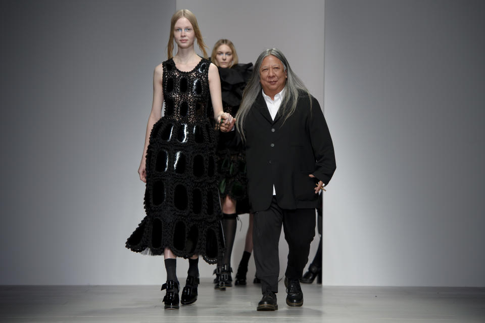 Hong Kong born designer John Rocha, right, walks the runway, during his London Fashion Week Autumn/Winter 2014 show, at Somerset House in central London, Saturday, Feb. 15, 2014. (Photo by Jonathan Short/Invision/AP)