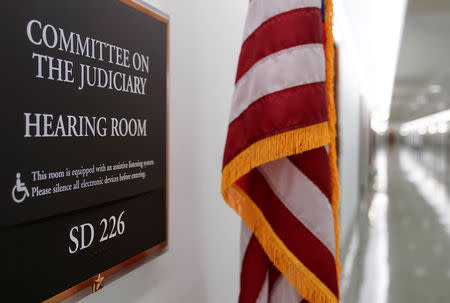 A flag stands next to the Senate Committee on the Judiciary on Capitol Hill in Washington, U.S., March 24, 2019. REUTERS/Joshua Roberts