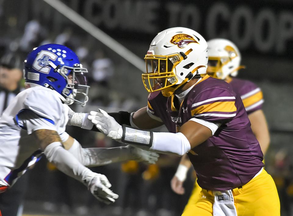 Austin Alexander of Cooper, right, shown during the Skyline Chili Crosstown Showdown in October 2022, will attend the Under Armour Next Football Camp in Columbus.