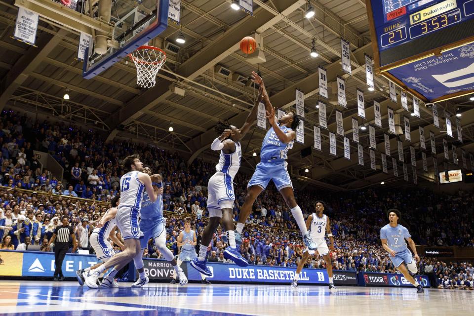 North Carolina's Harrison Ingram (55) attempts a shot over Duke's Mark Mitchell (25) during the first half of an NCAA college basketball game in Durham, N.C., Saturday, March 9, 2024. (AP Photo/Ben McKeown)