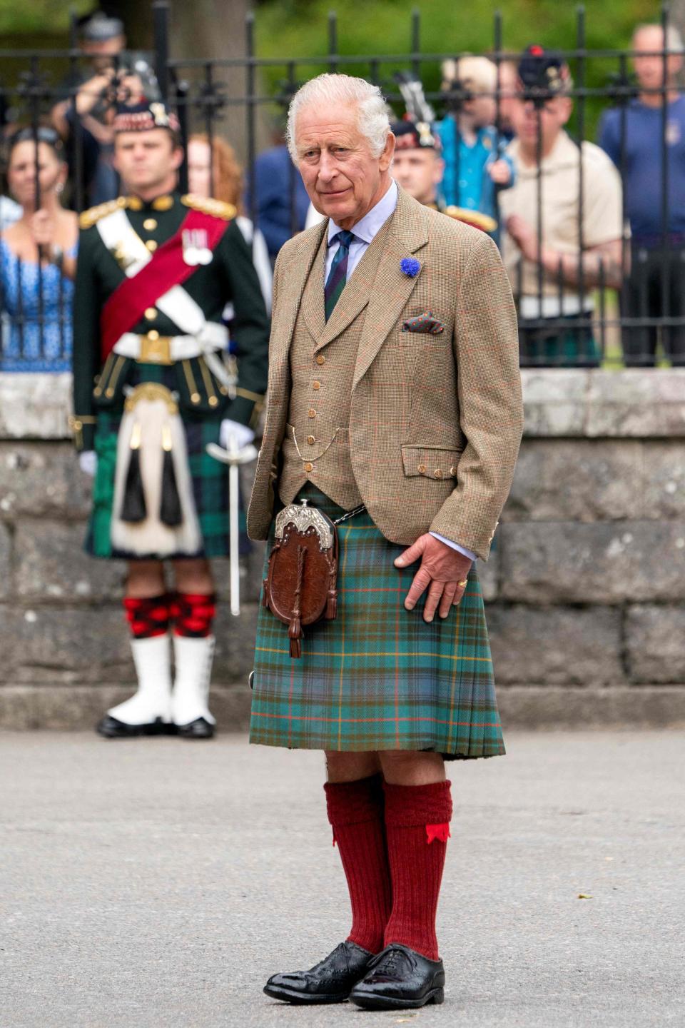 King Charles wore a multicolored kilt with a beige pinstripe blazer, light blue button-down shirt and red stockings.