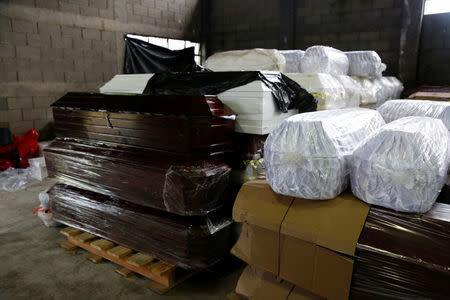 Coffins for the victims who died during the eruption of the Fuego volcano are seen at the morgue of Escuintla, Guatemala June 7, 2018. REUTERS/Luis Echeverria