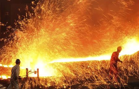 Employees work at a steel factory in Dalian, Liaoning province in this March 16, 2015 file picture. REUTERS/China Daily/Files