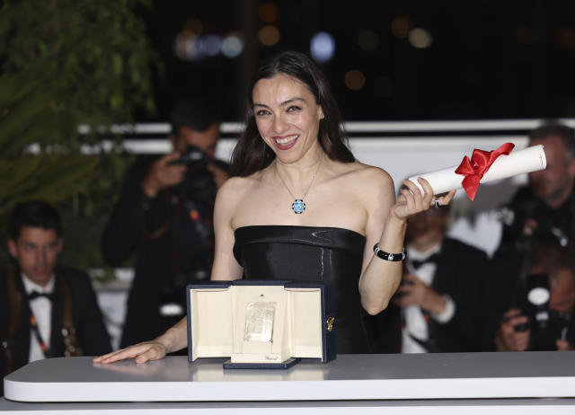 Merve Dizdar, winner of the award for best actress for 'About Dry Grasses,' poses for photographers during a photo call following the awards ceremony at the 76th international film festival, Cannes, southern France, Saturday, May 27, 2023. (Photo by Vianney Le Caer/Invision/AP)