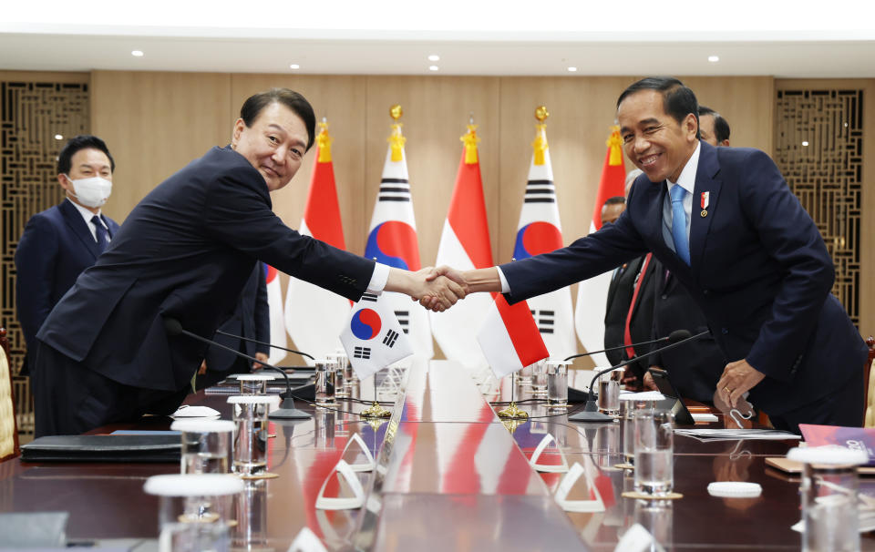 South Korean President Yoon Suk Yeol, left, shakes hands with Indonesian President Joko Widodo during a meeting at the presidential office in Seoul, South Korea, Thursday, July 28, 2022. (Suh Myung-gon/Yonhap via AP)