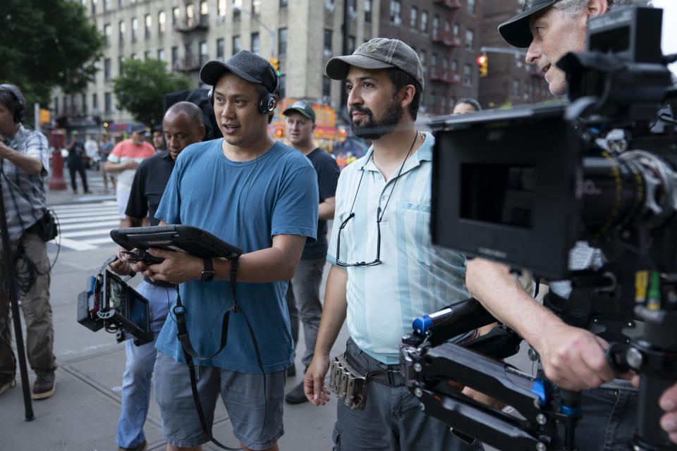 This image released by Warner Bros. Pictures shows director John Chu, left, and Lin-Manuel Miranda on the set of "In the Heights." (Macall Polay/Warner Bros. via AP)