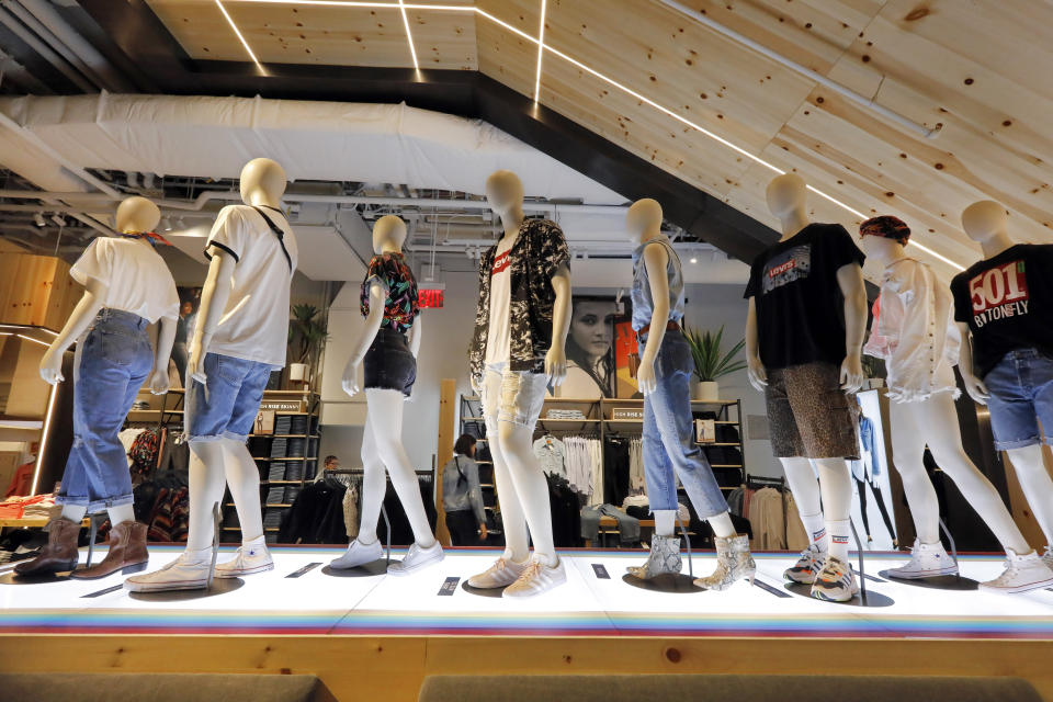 In this June 14, 2019, photo mannequins display Levi's products on the lower level of the Levi's store in the New York's Times Square. Levi Strauss & Co.’s new flagship in Manhattan’s Time Square features larger dressing rooms with call buttons and tailors who can add trims and patches to customers’ jeans. (AP Photo/Richard Drew)