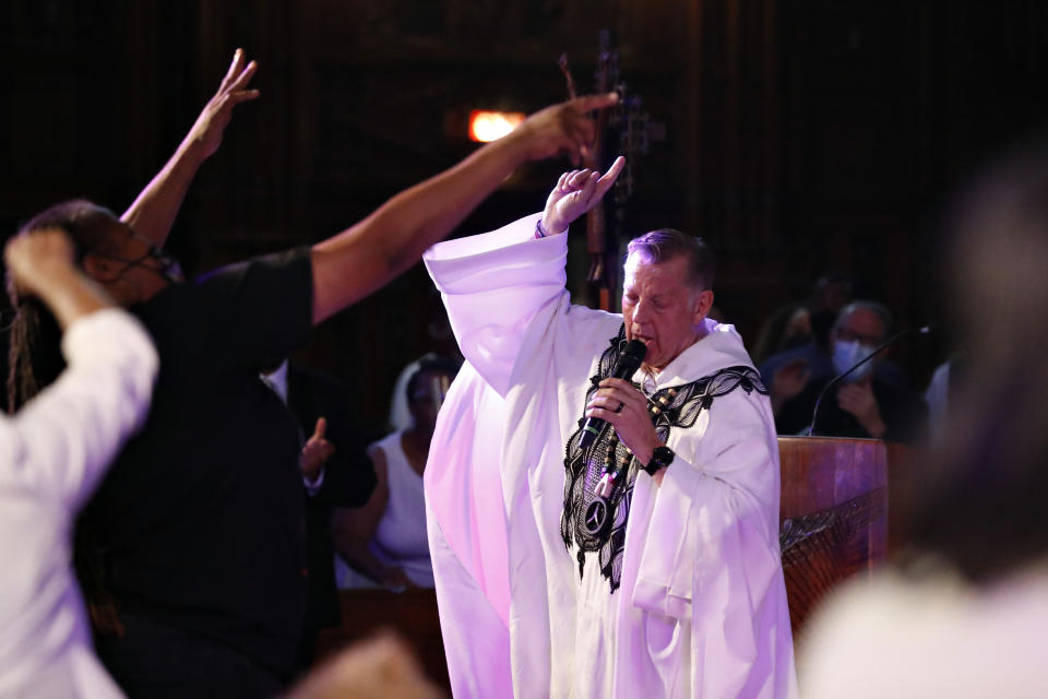 Rev. Michael Pfleger conducts his first Sunday church service as a senior pastor at St. Sabina Catholic Church following his reinstatement by Archdiocese of Chicago after decades-old sexual abuse allegations against minors, Sunday, June 6, 2021, in the Auburn Gresham neighborhood in Chicago. (AP Photo/Shafkat Anowar)