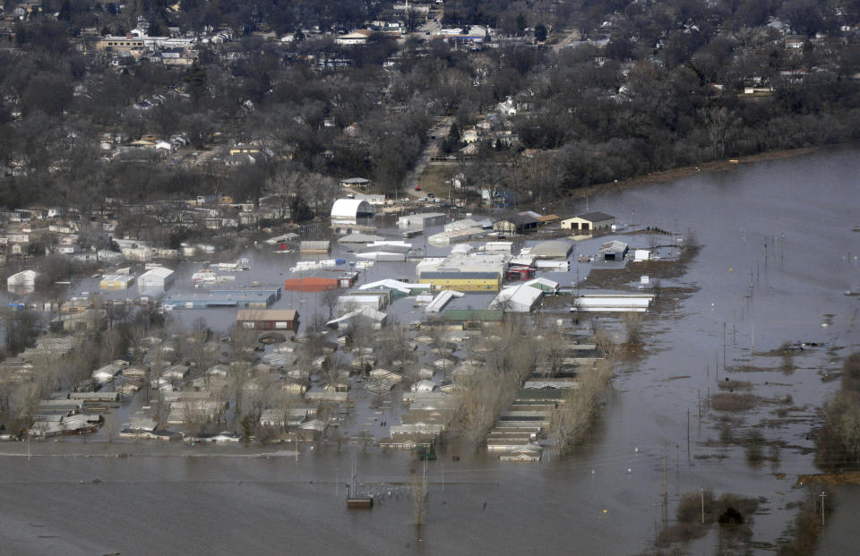 This March 17, 2019 photo released by the U.S. Air Force shows an aerial view of Areas surrounding Offutt Air Force Base affected by flood waters in Neb. Surging unexpectedly strong and up to 7 feet high, the Missouri River floodwaters that poured on to much the Nebraska air base that houses the U.S. Strategic Command overwhelmed the frantic sandbagging by troops and their scramble to save sensitive equipment, munitions and aircraft. (Tech. Sgt. Rachelle Blake/The U.S. Air Force via AP)