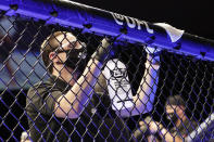 A worker wipes down areas of the octagon between bouts at a UFC 249 mixed martial arts event Saturday, May 9, 2020, in Jacksonville, Fla. (AP Photo/John Raoux)