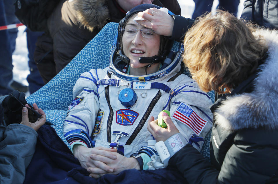 Specialists help U.S. astronaut Christina Koch shortly after the landing of the Russian Soyuz MS-13 space capsule about 150 km ( 80 miles) south-east of the Kazakh town of Dzhezkazgan, Kazakhstan, Thursday, Feb. 6, 2020. A Soyuz space capsule with U.S. astronaut Christina Koch, Italian astronaut Luca Parmitano and Russian cosmonaut Alexander Skvortsov, returning from a mission to the International Space Station landed safely on Thursday on the steppes of Kazakhstan. Koch wrapped up a 328-day mission on her first flight into space, providing researchers the opportunity to observe effects of long-duration spaceflight on a woman as the agency plans to return to the Moon under the Artemis program. (Sergei Ilnitsky/Pool Photo via AP)