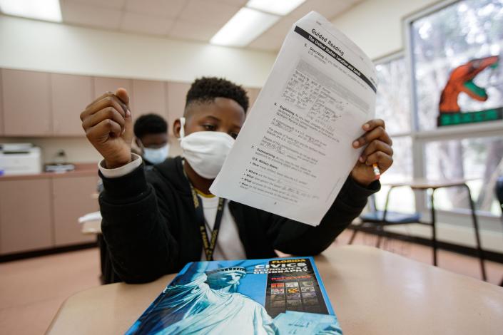 Raquez Sneed works on a civics packet in a new pilot program at Nims Middle School the helps overage fifth graders students speed through sixth grade and catch up to their peers Thursday, Jan. 20, 2022.