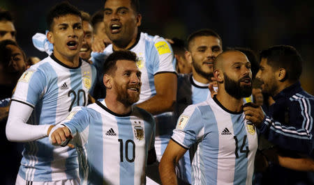 Soccer Football - 2018 World Cup Qualifiers - Ecuador v Argentina - Olimpico Atahualpa stadium, Quito, Ecuador - October 10, 2017. Argentina's Lionel Messi, Javier Mascherano (14) and other teammates celebrate at the end of the match. REUTERS/Edgard Garrido