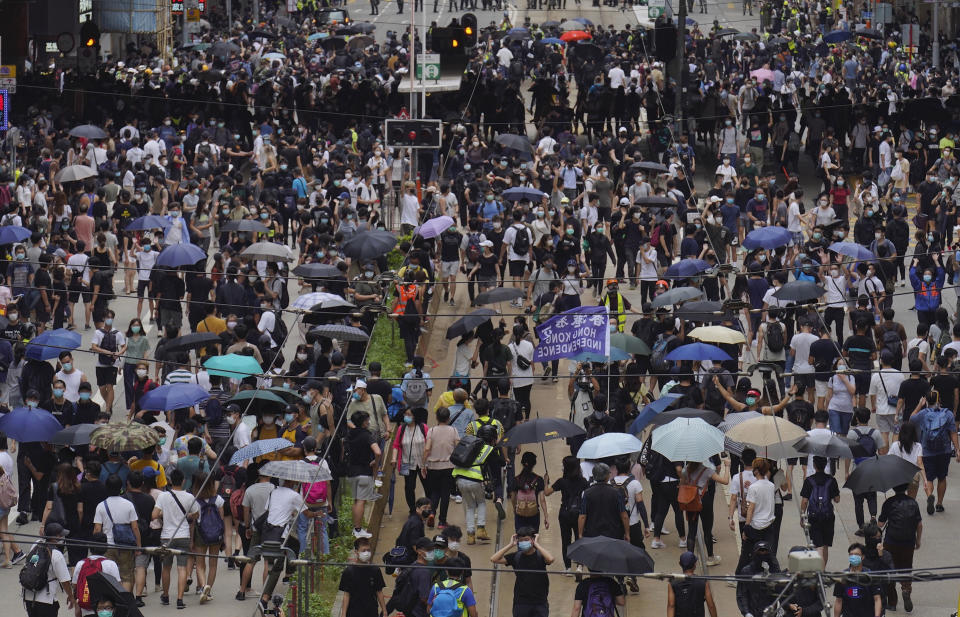 Pro-democracy protesters march during a protest against Beijing's national security legislation in Hong Kong, Sunday, May 24, 2020. Hong Kong's pro-democracy camp has sharply criticized China's move to enact national security legislation in the semi-autonomous territory. They say it goes against the "one country, two systems" framework that promises the city freedoms not found on the mainland. (AP Photo/Vincent Yu)