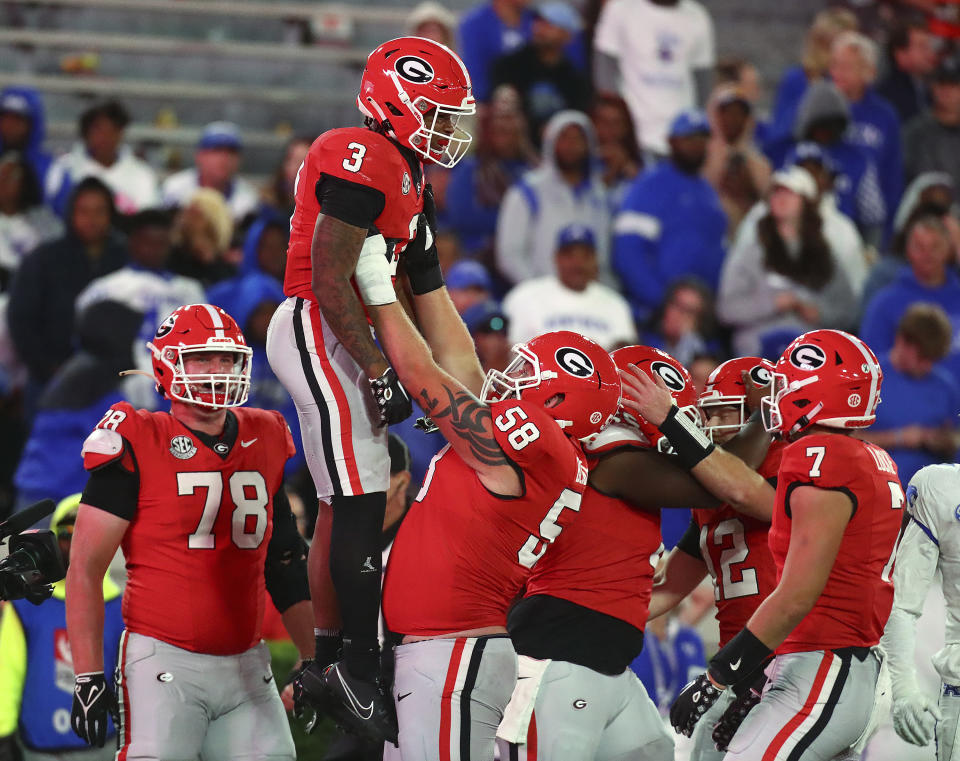 Georgia running back Andrew Paul gets a hoist from offensive lineman Austin Blaske after scoring a touchdown against Kentucky during the fourth quarter of an NCAA college football game Saturday, Oct. 7, 2023, in Athens, Ga. (Curtis Compton/Atlanta Journal-Constitution via AP)