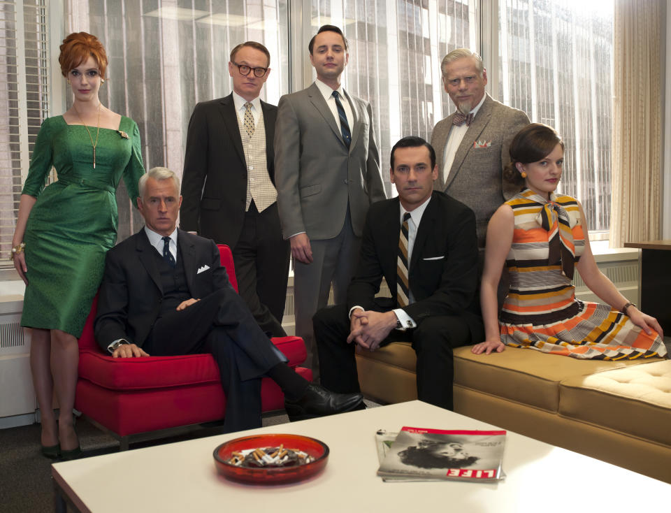 In this undated image released by AMC, the cast of "Mad Men," from left, Christina Hendricks, John Slattery, Jared Harris, Vincent Kartheiser, Jon Hamm, Robert Morse and Elisabeth Moss are shown. The fifth season the stylized AMC drama about the men and women who work in Madison Avenue advertising in the 1960s, premieres March 25, 2012 at 9 p.m. EST on AMC. (AP Photo/AMC, Frank Ockenfels)