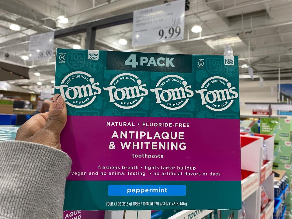 The writer holds a four-pack of Tom&#39;s toothpaste in teal and purple packaging