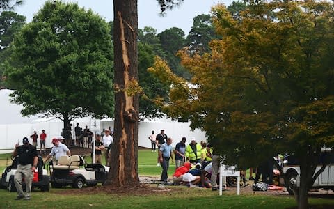 Fans are assisted by medical personnel after a lightning strike during the third round of the Tour Championship golf tournament at East Lake Golf Club - Credit: USA TODAY Sports