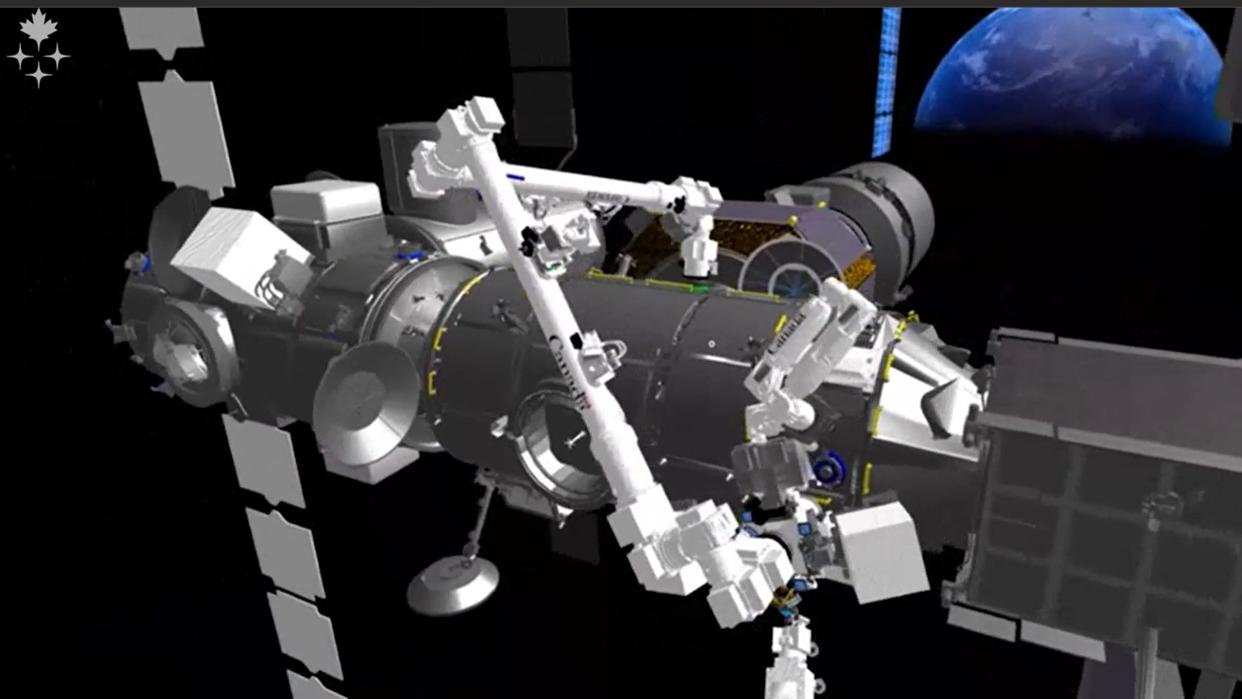  The gateway space station modules and the canadarm3 in a simulated environment. in back is a large earth for illustrative purposes only. 