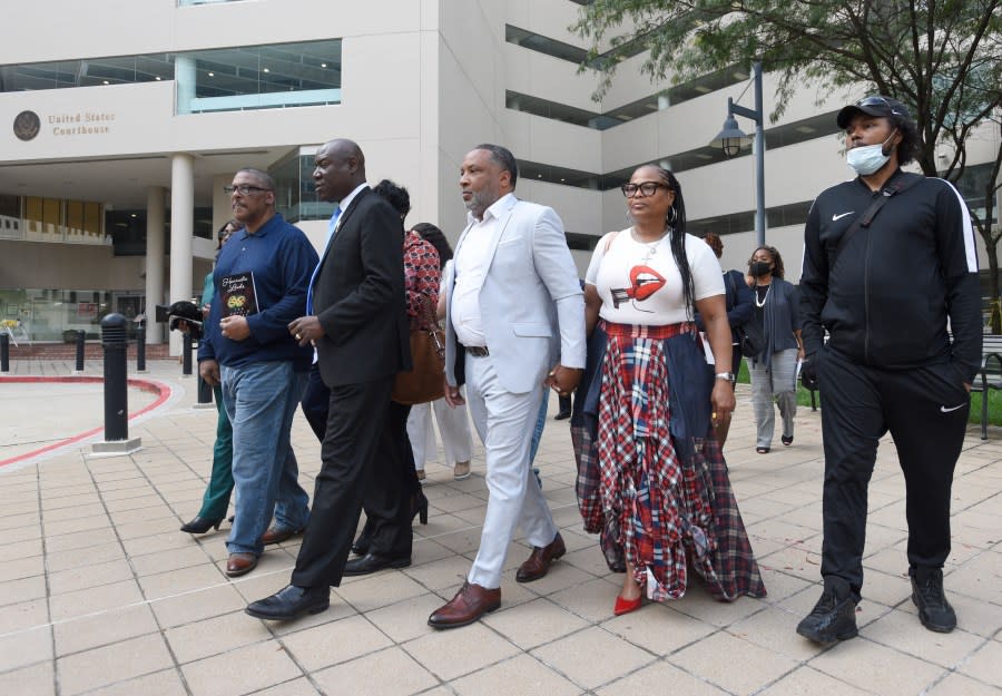 Attorney Ben Crump, second from left, walks with Ron Lacks, left, Alfred Lacks Carter, third from left, both grandsons of Henrietta Lacks, and other descendants of Lacks, outside the federal courthouse on Oct. 4, 2021, in Baltimore. The family of Henrietta Lacks is settling a lawsuit against a biotechnology company it accuses of improperly profiting from her cells. Their federal lawsuit in Baltimore claimed Thermo Fisher Scientific has made billions from tissue taken without the Black woman’s consent from her cervical cancer tumor. (AP Photo by Steve Ruark, file)