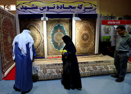 People look at the carpets displayed at the Iran section of the Baghdad International Fair, in Baghdad, Iraq November 10, 2018. REUTERS/Thaier al-Sudani