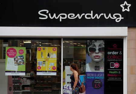 A woman walks past a branch of Superdrug in Loughborough, Britain. Aug 22, 2018. REUTERS/Darren Staples