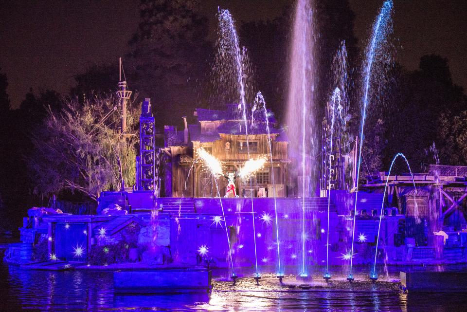 Mickey comes out on stage to begin the live Disneyland show Fantasmic.