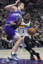 Minnesota Timberwolves guard Anthony Edwards (1) drives to the basket as Utah Jazz forward Kelly Olynyk (41) defends during the first half of an NBA basketball game Wednesday, Feb. 8, 2023, in Salt Lake City. (AP Photo/Rick Bowmer)