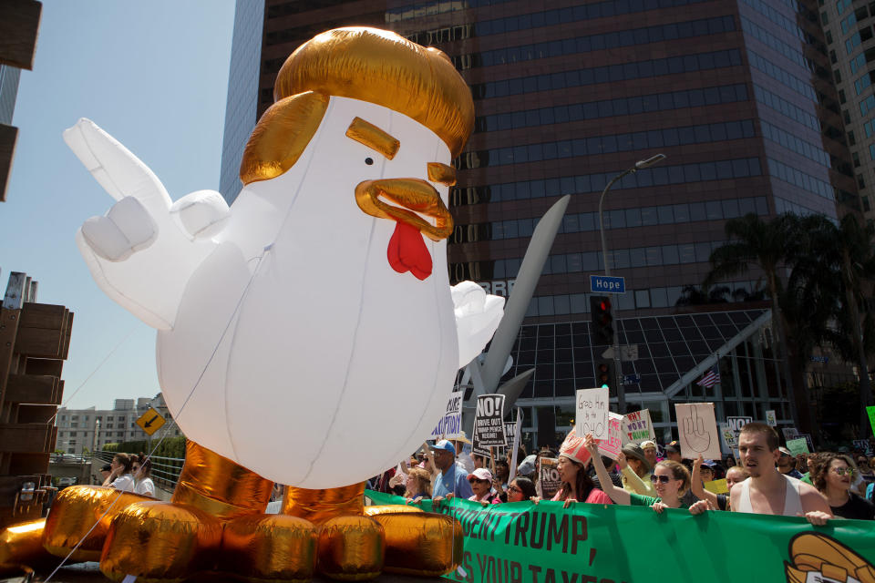 An inflatable chicken sits on a truck bed as demonstrators march towards City Hall during the Tax March Los Angeles in Los Angeles, California, U.S., on Saturday, April 15, 2017. The Tax March is an organized nation wide protest, held on the traditional deadline date to file taxes, that seeks to promote transparency by calling on U.S. President Donald Trump to release his personal tax returns. Photographer: Troy Harvey/Bloomberg via Getty Images