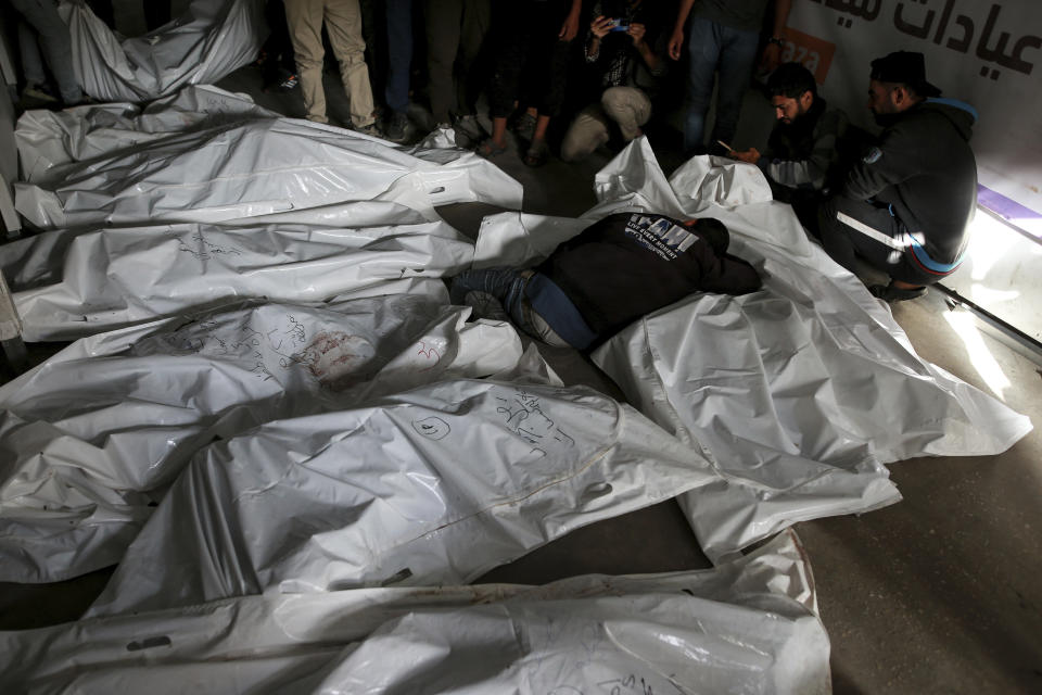 Palestinians mourn over the bodies of relatives killed in an Israeli airstrike, at a morgue in Rafah, Gaza Strip, Monday, May 27, 2024. Palestinian health workers said Israeli airstrikes Sunday killed at least 35 people sheltering in a tent camp for displaced people. Israel's army confirmed the strike and said it hit a Hamas installation and killed two senior Hamas militants. (AP Photo/Jehad Alshrafi)