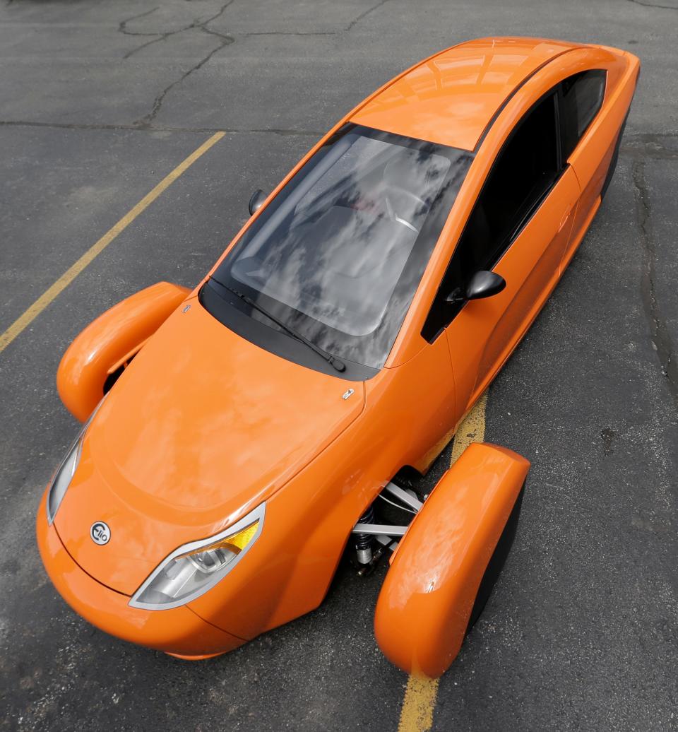 In this Thursday, Aug. 14, 2014, file photo, the Elio, a three-wheeled prototype vehicle, is shown in Royal Oak, Mich.