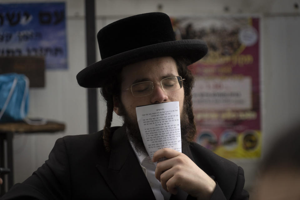 An Orthodox Jew prays at the tomb of Rabbi Nachman, the great grandson of the founder of Hasidic movement, in the town of Uman, 200 kilometers (125 miles) south of Ukraine's capital Kiev, Ukraine, Sunday, Sept. 25, 2022. Thousands of Hasidic Jewish pilgrims flocked to central Ukraine to mark the Jewish new year Sunday, ignoring international travel warnings as Russia struck more targets from the air and mobilized its citizens to stem losses in the war that has entered its eighth month. (AP Photo/Efrem Lukatsky)