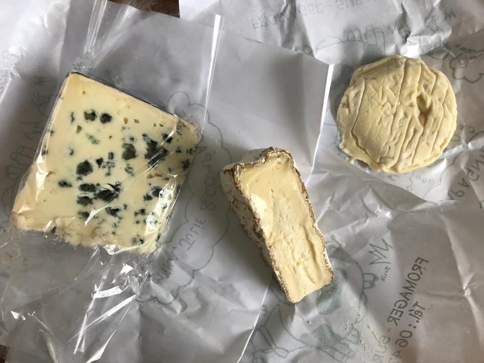 three kinds of cheese laid out on white butcher paper