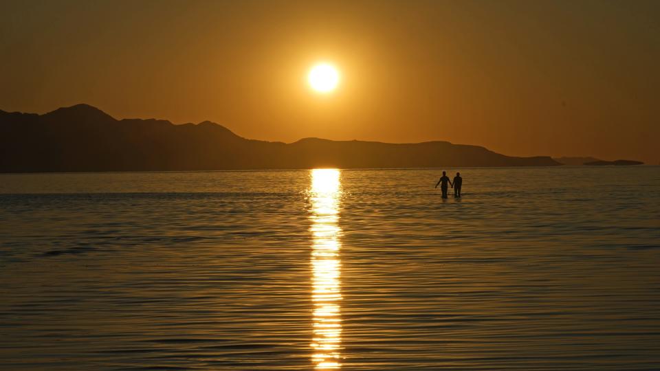 FILE - The sun sets on the Great Salt Lake on June 15, 2023, near Magna, Utah. A coalition of environmental organizations sued the state of Utah on Wednesday, Sept. 6, 2023, based on accusations that it is not doing enough make sure enough water gets to the shrinking Great Salt Lake. (AP Photo/Rick Bowmer)