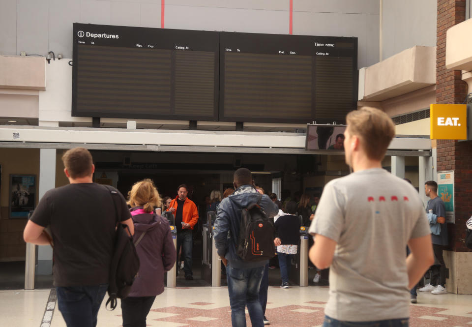 People walking through Clapham Junction station in London during a power cut, which has caused �apocalyptic� rush-hour scenes across England and Wales, with traffic lights down and trains coming to a standstill.